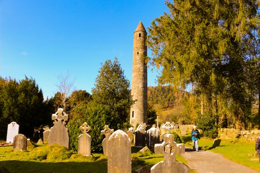 GLENDALOUGH, IRELAND - February 19 2018: The ancient cemetery in monastic site Glendalough. Glendalough Valley, Wicklow Mountains National Park, Ireland. Glendalough is home to one of the most important monastic sites in Ireland. This early Christian monastic settlement was founded by St. Kevin in the 6th century and from this developed the 'Monastic City'.