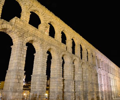Night view of famous ancient aqueduct in Segovia, Castilla y Leon, Spain.