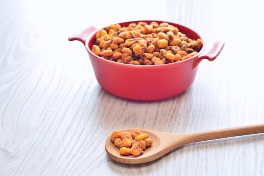Toasted corn on the wooden table in the kitchen.