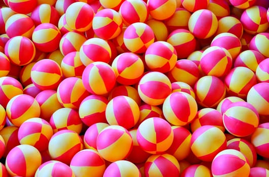 Heap of pink and yellow toy balls.