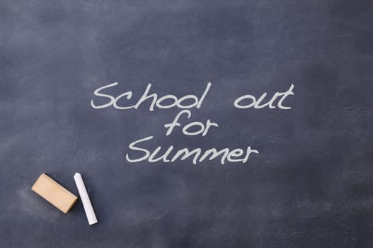 Blackboard with the phrase School out for summer.