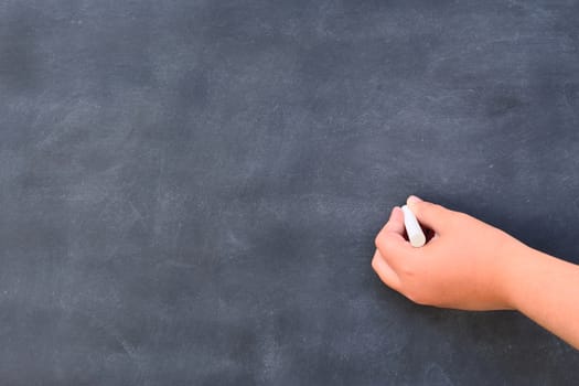 Hand writing on the blackboard at school.