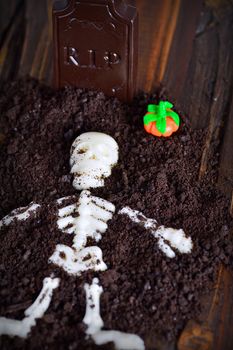 Tomb with skeleton made with chocolate for halloween.