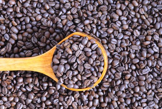 Coffee beans of the highest quality on the wooden table.