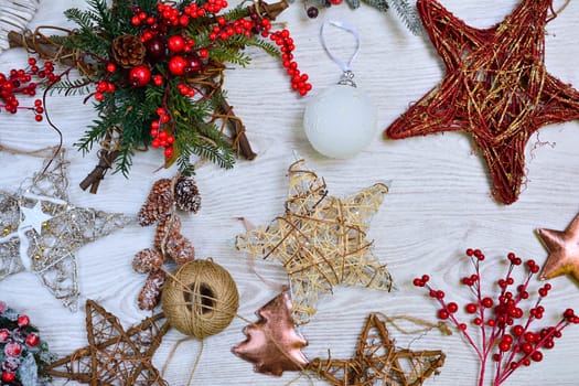 Different handmade Christmas tree decorations on wooden table. From above.