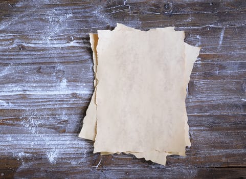 Parchment on wooden table in the kitchen.