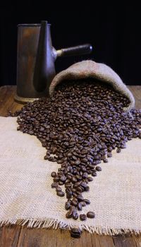 Coffee beans of the highest quality on the wooden table.