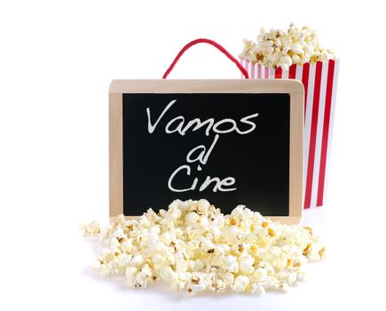 Popcorn and blackboard on a wooden table