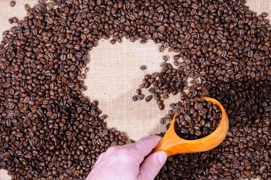 Coffee beans of the highest quality on the wooden table.