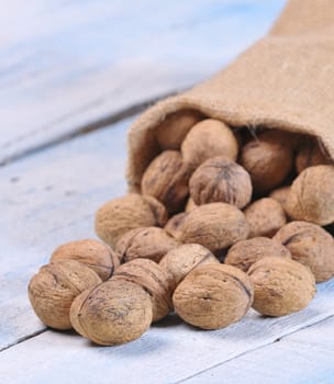 Walnuts on wooden table in the kitchen.