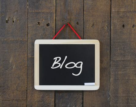 Blackboard on a wooden wall with the word Blog.