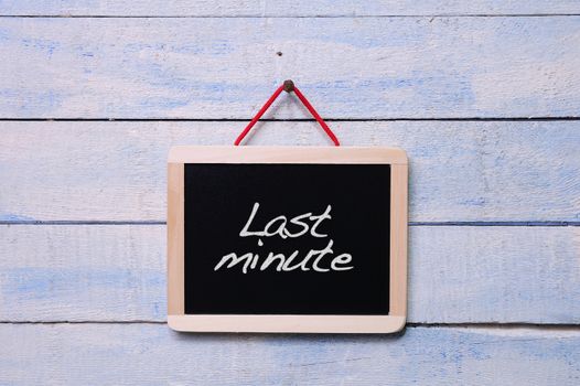 Blackboard on the wall with the phrase Last minute.