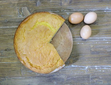 Sponge cake on a plate in a wooden table.