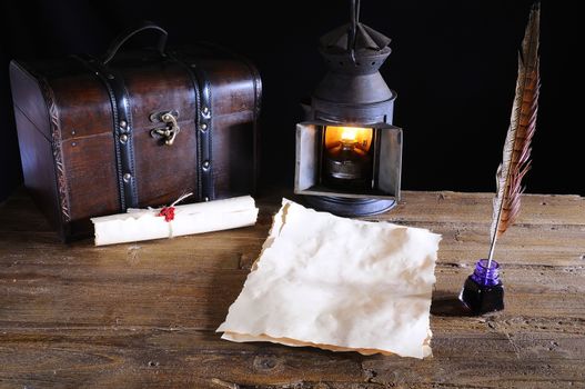 Work desk with parchment, inkwell and pen.