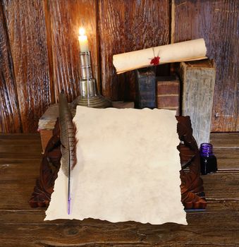 Work desk with parchment and old books.