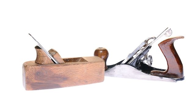 Antique woodworking tools on white background