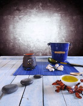 Wooden table in the sauna area with oils and hot stones.