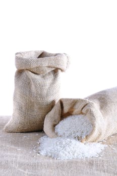 Sack of rice isolated on a burlap.