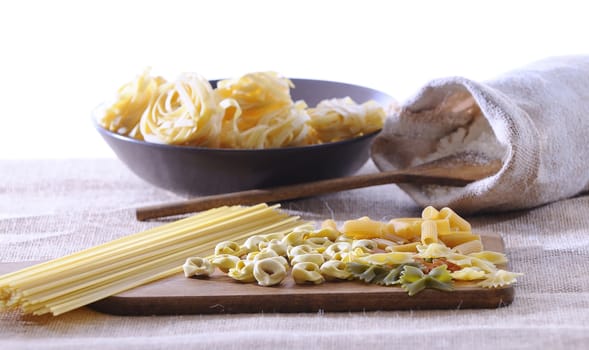 Preparing pasta on the kitchen table with white background