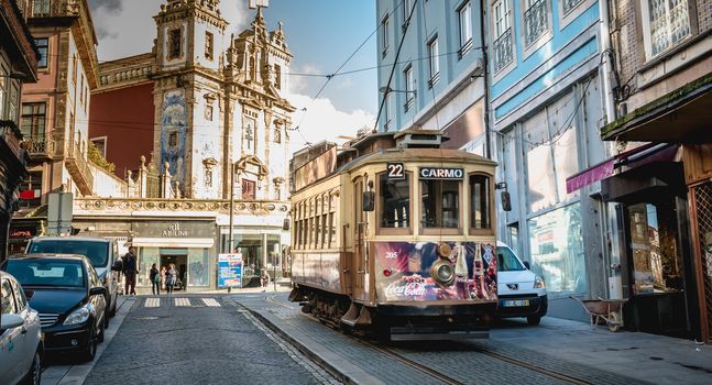 Porto, Portugal - November 30, 2018: Traditional electric tram flowing through the streets of the city on a fall day