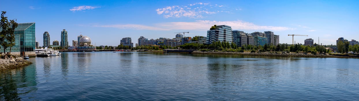 Panorama of Vancouver British Columbia skyline showing the beautiful science world building and the water front.