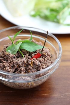 Thai food minced meat with vegetable and chilli on wood background