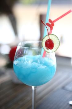 Blue cocktail with cherry and lime , kamikaze