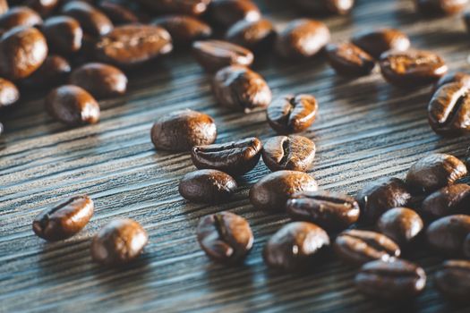 Coffee beans. On a wooden background.