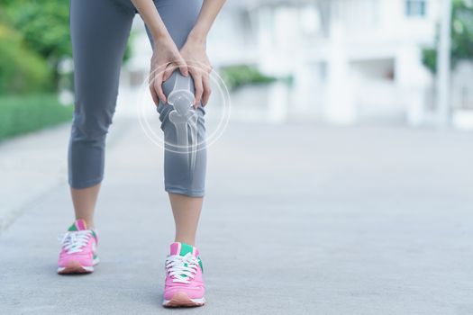 Woman holds her hands to the knee, pain in the knee, medicine, massage concept.