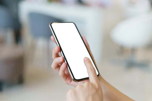 Mockup image of hand holding mobile phone with blank white screen.