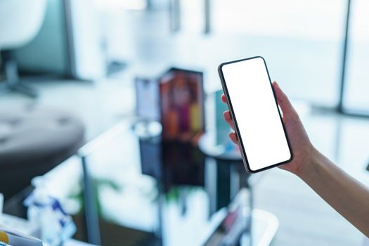 Woman hand showing smart phone blank screen.