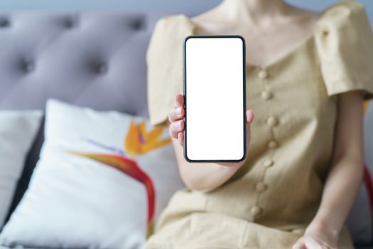 Woman hand showing smart phone blank screen.