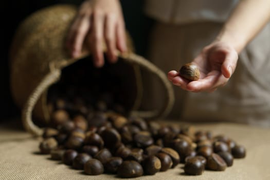 Close-up of wicker basket with full of chestnuts.