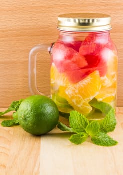 Picture of infused water and lime on wooden background