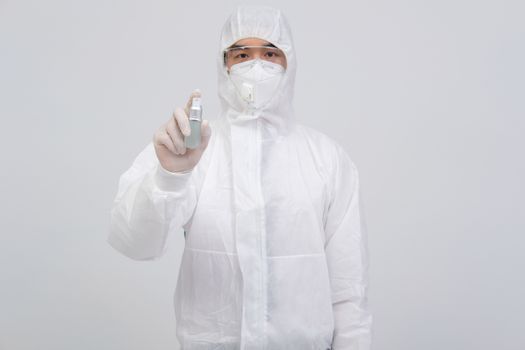 man doctor wearing biological protective uniform suit clothing, mask, gloves with hand alcohol sanitizer dispenser for sanitizing virus bacteria