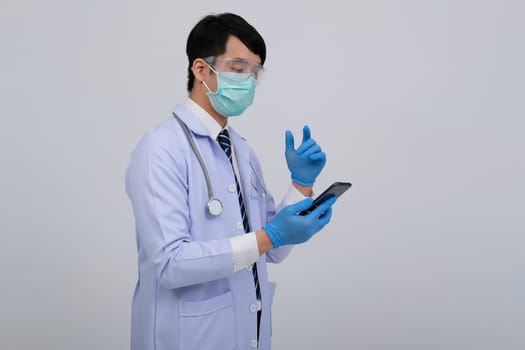 doctor physician practitioner wearing mask with smartphone & stethoscope on white background. medical professional medicine healthcare concept