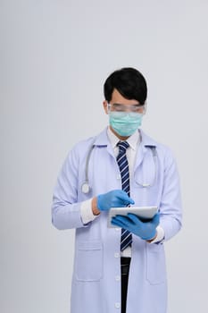 doctor physician practitioner wearing mask with tablet & stethoscope on white background. medical professional medicine healthcare concept