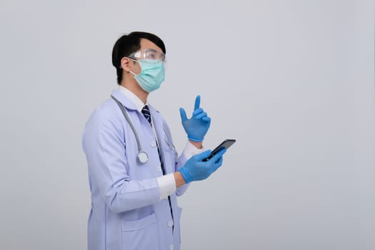 doctor physician practitioner wearing mask with smartphone & stethoscope on white background. medical professional medicine healthcare concept