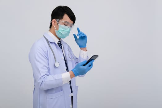 doctor physician practitioner wearing mask with smartphone & stethoscope on white background. medical professional medicine healthcare concept