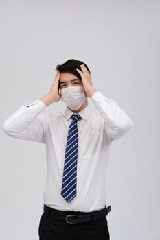ill businessman man feeling sick, headache wearing protective mask against cold flu virus bacteria infection pollution