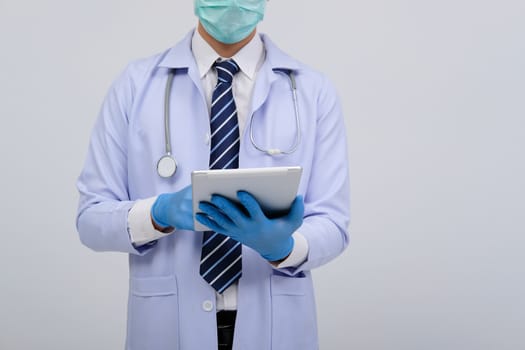 doctor physician practitioner wearing mask with tablet & stethoscope on white background. medical professional medicine healthcare concept