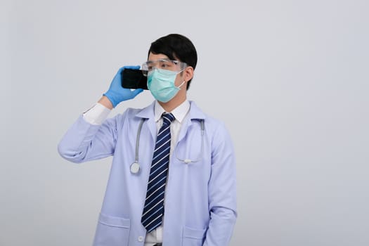 doctor physician practitioner wearing mask with smartphone & stethoscope on white background. medical professional medicine healthcare concept