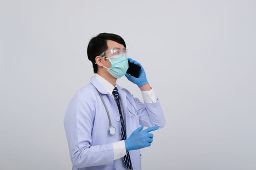 doctor physician practitioner wearing mask with smartphone & stethoscope on white background. medical professional medicine healthcare concept