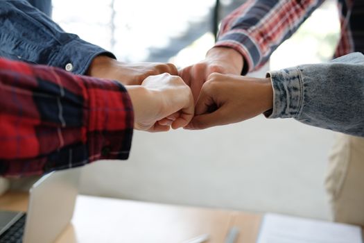 startup man woman joining united hand, business team touching hands together after complete a deal in meeting. unity teamwork partnership corporate concept.