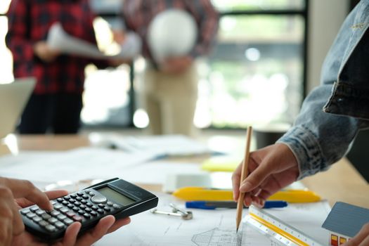 architect engineer interior designer team working discussing on house blueprint of real estate project in meeting. building construction teamwork concept