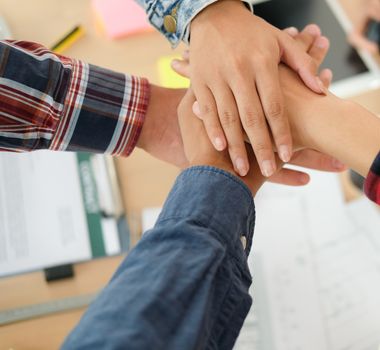 startup man woman joining united hand, business team touching hands together after complete a deal in meeting. unity teamwork partnership corporate concept.