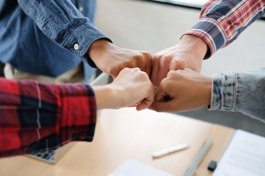 startup man woman joining united hand, business team touching hands together after complete a deal in meeting. unity teamwork partnership corporate concept.