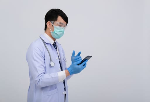 doctor physician practitioner wearing mask with smartphone & stethoscope on white background. medical professional medicine healthcare concept