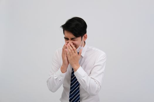 ill businessman man feeling sick, sneezing coughing wearing protective mask against cold flu virus bacteria infection pollution