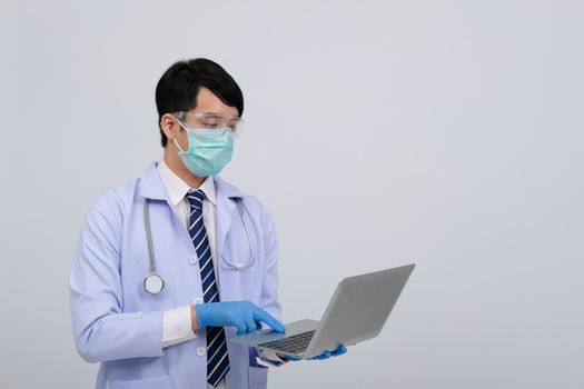 doctor physician practitioner wearing mask with computer & stethoscope on white background. medical professional medicine healthcare concept